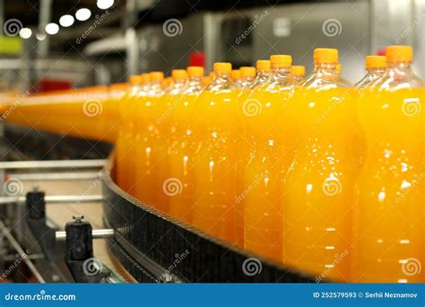 Production of Carbonated Drinks. Orange Bottles on the Production Line ...