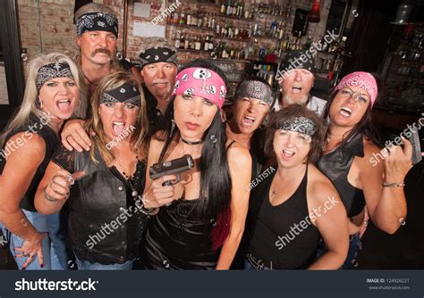 Serious Pretty Biker Woman Holding Pistol With Group Stock Photo ...