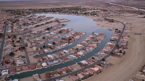 5K aerial video orbit lakeside homes in a small desert town in ...