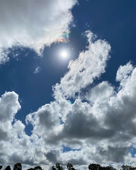 the sun shines brightly through some clouds