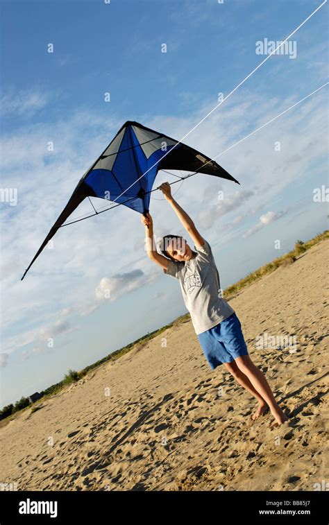 Boy flying kite, kite flying, kiting on the beach Stock Photo - Alamy