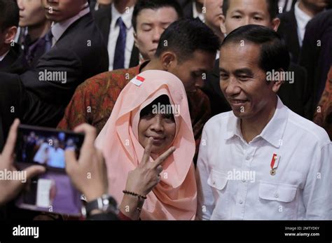 Indonesian President Joko "Jokowi" Widodo, right, poses with an ...