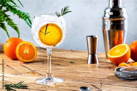 Gin tonic orange cocktail with dry gin, bitter tonic, rosemary and ice ...