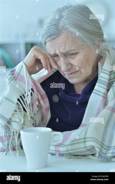 Portrait of a sad old woman crying at home Stock Photo - Alamy