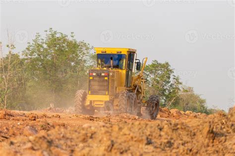 Road grader tractor working at road construction site, motor grader ...