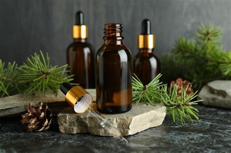 Premium Photo | Aromatherapy concept with pine oil on black smoky table