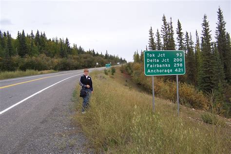 Karin at milepost marker sign | at Alaska border | Mike Radigan | Flickr