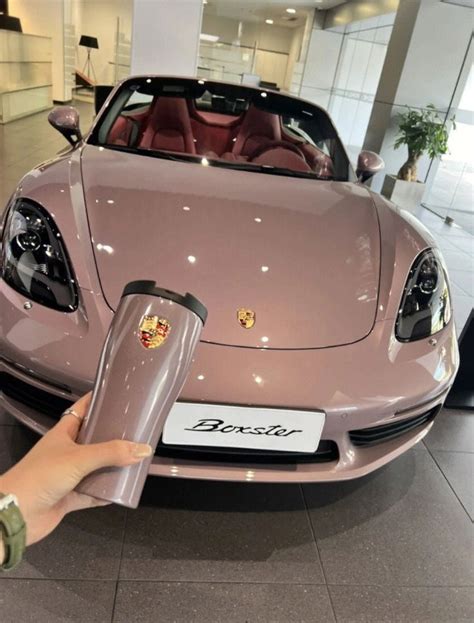 a pink sports car is on display in a showroom