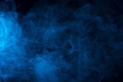 Premium Photo | Blue smoke texture on a black background