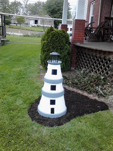 Covering up the well casing with a lighthouse for Gerri.