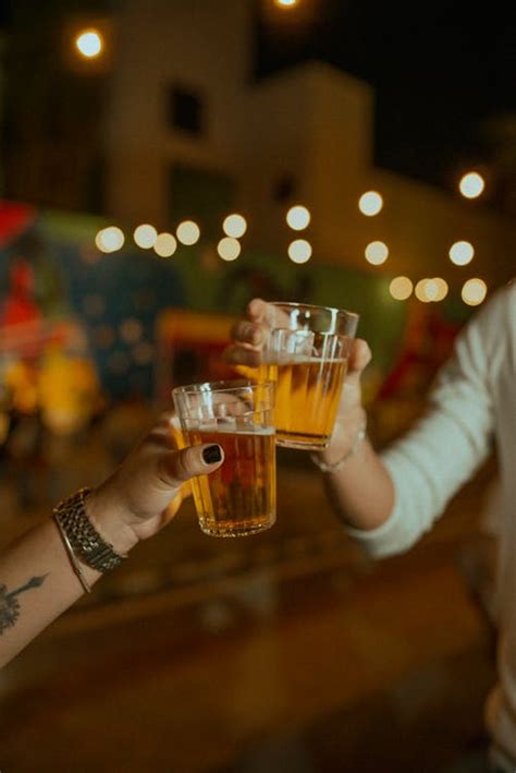 Two Women Making Toast with Beer · Free Stock Photo