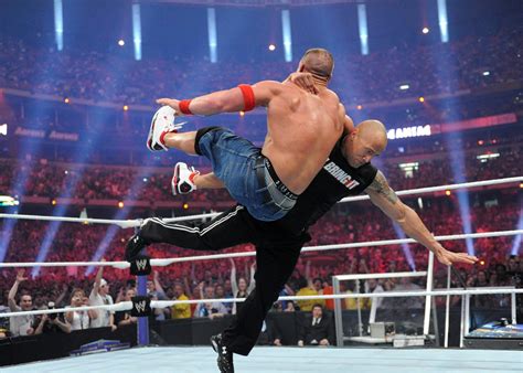 two men are wrestling in an arena