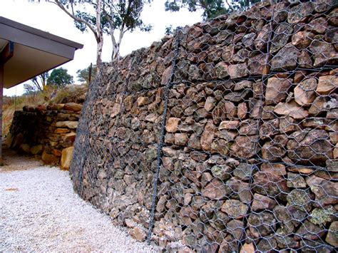 Rock Science: building our gabion wall - Milkwood: permaculture courses ...