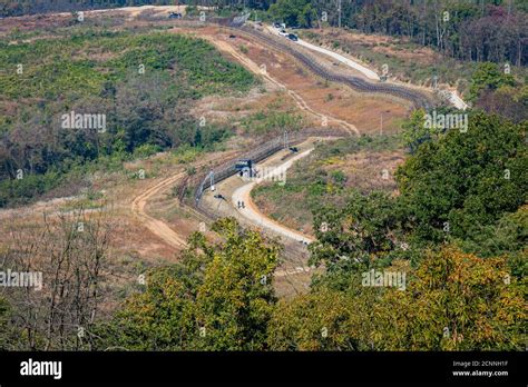 Highly fortified border fence at the Korean DMZ, with watch towers ...