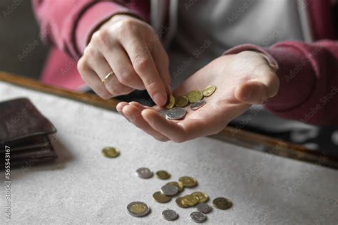 Young man counting coins on table in a period of crisis. Poor man holds ...