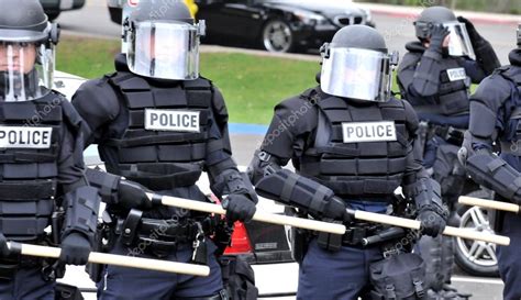 Moving toward the riot - police officers in protective gear – Stock ...