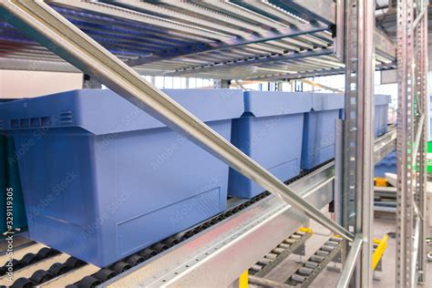 Automated storage warehouse with blue plastic crates Stock Photo ...