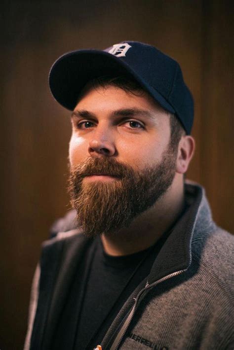 a man with a beard wearing a baseball cap