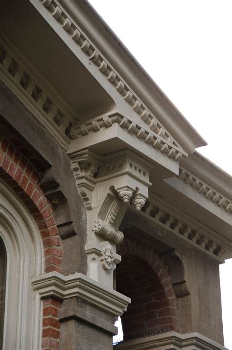 the corner of an old building with brick and stucco