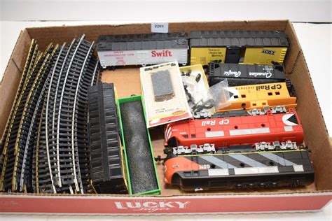 Selection of HO scale train accessories including electric engines ...