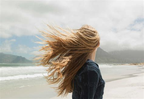 Young womans hair blowing in wind stock photo