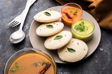 Premium Photo | Idly sambar or idli with sambhar and green, red chutney ...