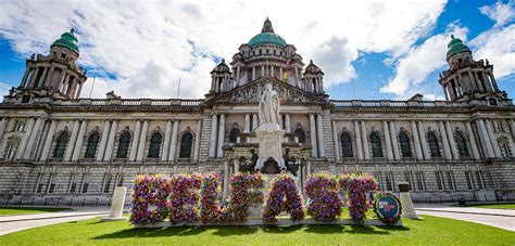 Download a large building with flowers in front of it Wallpaper ...