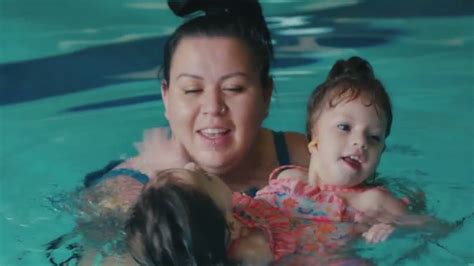 a woman and her child are in the pool