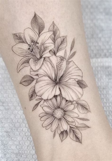 a black and white flower tattoo on the ankle