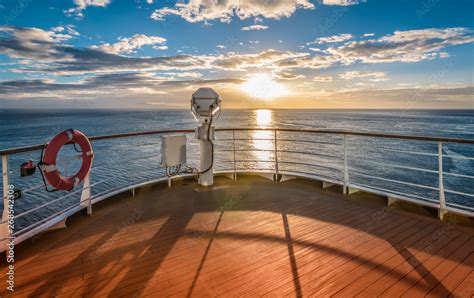 Wooden deck and railing from cruise ship. Beautiful sunset and ocean ...