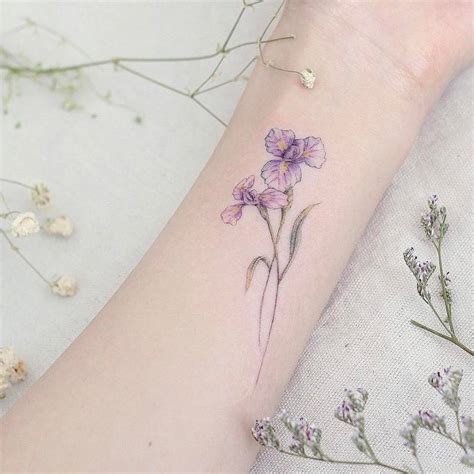 Iris flower tattoo on the inner forearm.