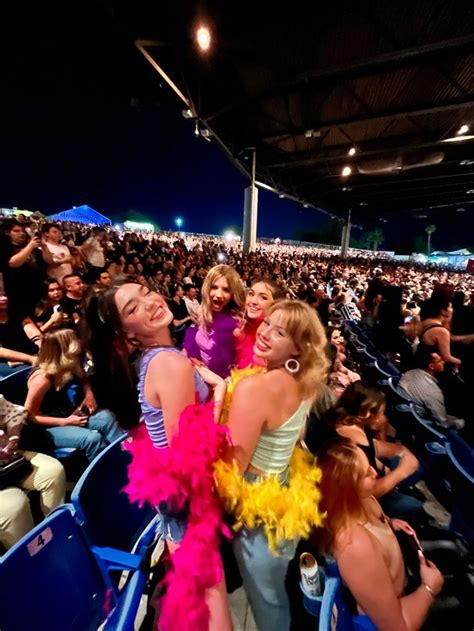 two women are hugging in the stands at an event