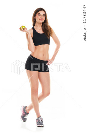 Young athletic girl with a green apple on a white 11733447