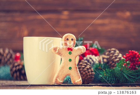 Gingerbread man near cup and Pine branch 13876163