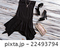 Black sleeveless dress with shoes. 22493794