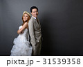 young asian groom and bride smiling in studio 31539358