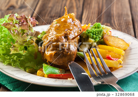 Pork rolls with prepared potatoes and vegetables 32869068