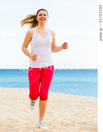 Woman running on beach 33755585