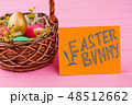 Woven basket filled with Easter eggs. 48512662