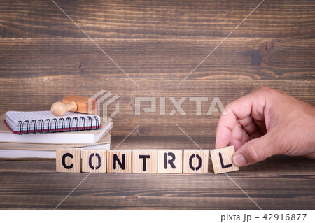 control. Wooden letters on the office desk 42916877