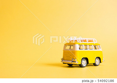 Funny yellow retro car with surfboard  54092186