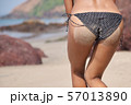 Slender young woman in dressed in black bikini 57013890