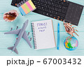 Flat lay composition with airplane, globe, seashells and notepad on blue desk. 67003432