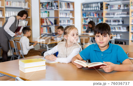 Two school children reading in school library 76036737