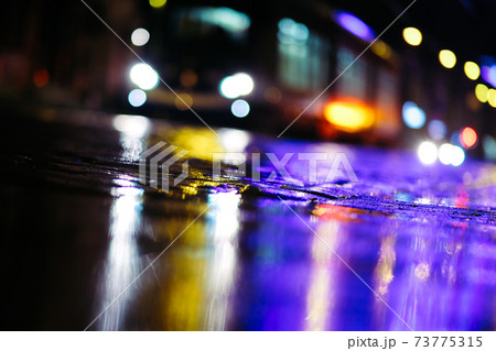 Beautiful night city lights and traffic lights, public transportation in night. Blurred background. Selective focus 73775315