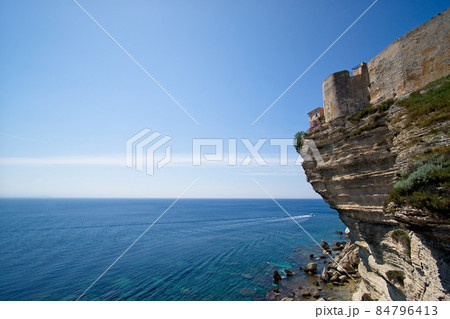 Blue and turquoise mediterranean sea below the Cliff  and city of of Bonifacio on a beautiful spring day 84796413