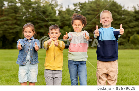 happy children showing thumbs up at park 85679629