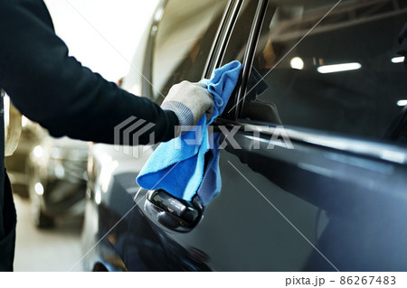 Close up of male car service worker applying nano coating on a car 86267483