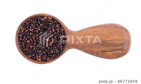 Black quinoa seeds in wooden spoon, isolated on white background. Pile of raw kinwa. Top view. 86773849