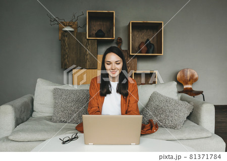 A beautiful european young woman using a laptop for remote work from home. 81371784